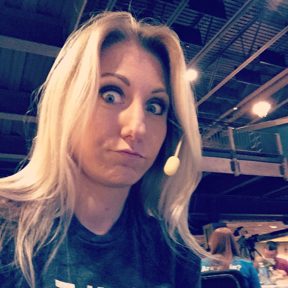 blonde woman with silly look on her face wearing a headset